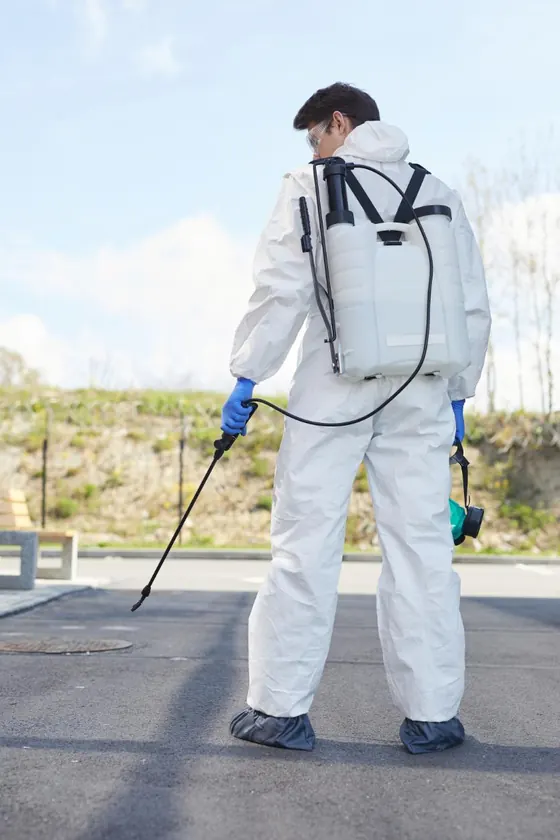 Technician working along an outdoor property surface for Mosquito Control